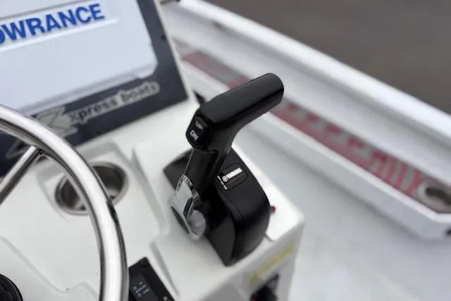 Slide: The Image of 2024 Express H22B boat throttle control on dashboard, featuring steering wheel and control panel. - 39