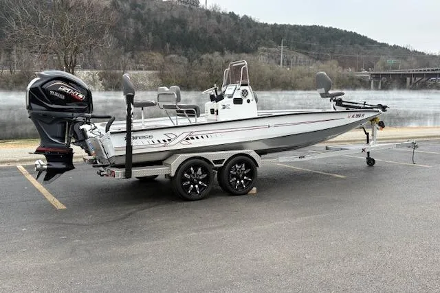 Slide: The Image of 2024 Express H22B boat on trailer by a lake, featuring Yamaha outboard motor. - 4