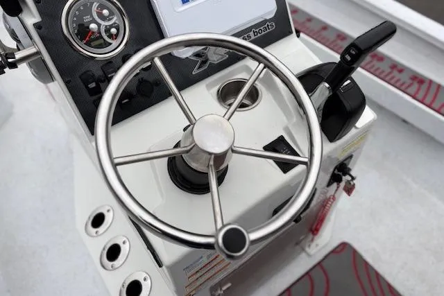 Slide: The Image of 2024 Express H22B boat steering console with gauges and controls. - 40