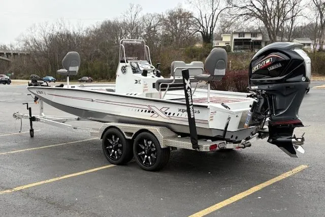 Slide: The Image of 2024 Express H22B boat with Yamaha engine on a trailer in a parking lot. - 5