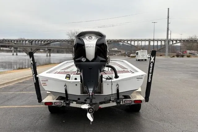 Slide: The Image of 2024 Express H22B boat with powerful engine, parked near a scenic river and bridge. - 51