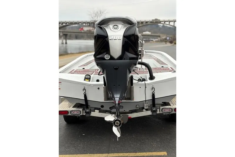 Slide: The Image of 2024 Express H22B boat with powerful 200 HP outboard motor on trailer. - 52