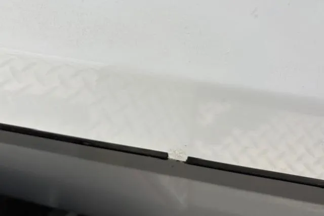 Slide: The Image of 2024 Express H22B vehicle detail showing a close-up of a white surface with a subtle pattern. - 62