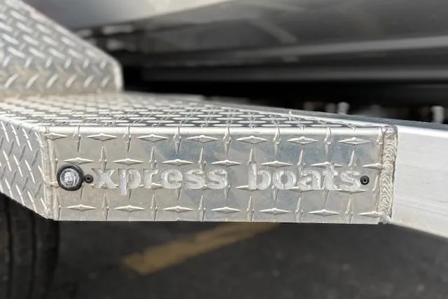 Slide: The Image of 2024 Express H22B boat trailer with diamond plate design and embossed branding. - 65