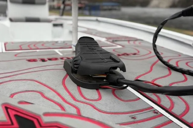 Slide: The Image of 2024 Express H22B boat deck with red accents and mounted equipment. - 70