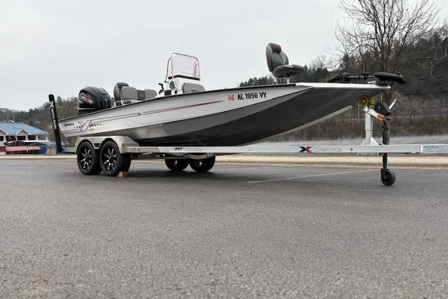 Slide: The Image of 2024 Express H22B boat on trailer, parked outdoors, showcasing sleek design and dual motors. - 8