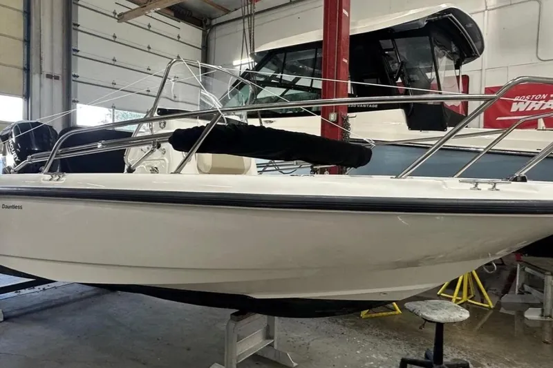 Slide: The Image of 2012 Boston Whaler 180 Dauntless boat in a garage setting. - 3