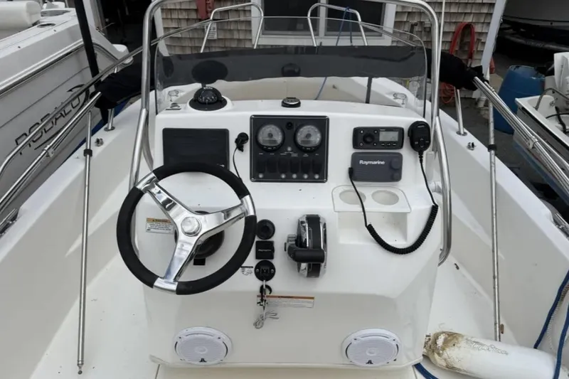 Slide: The Image of 2012 Boston Whaler 180 Dauntless boat console with steering wheel and navigation controls. - 6