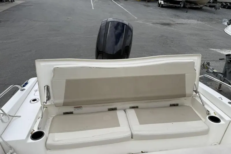 Slide: The Image of 2012 Boston Whaler 180 Dauntless boat with cushioned seating and outboard motor. - 8
