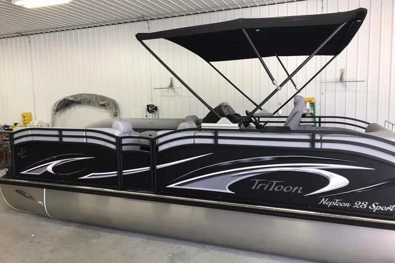 The Image of 2026 JC NEPTOON SPORT 21TT pontoon boat with canopy in a garage setting. - 1