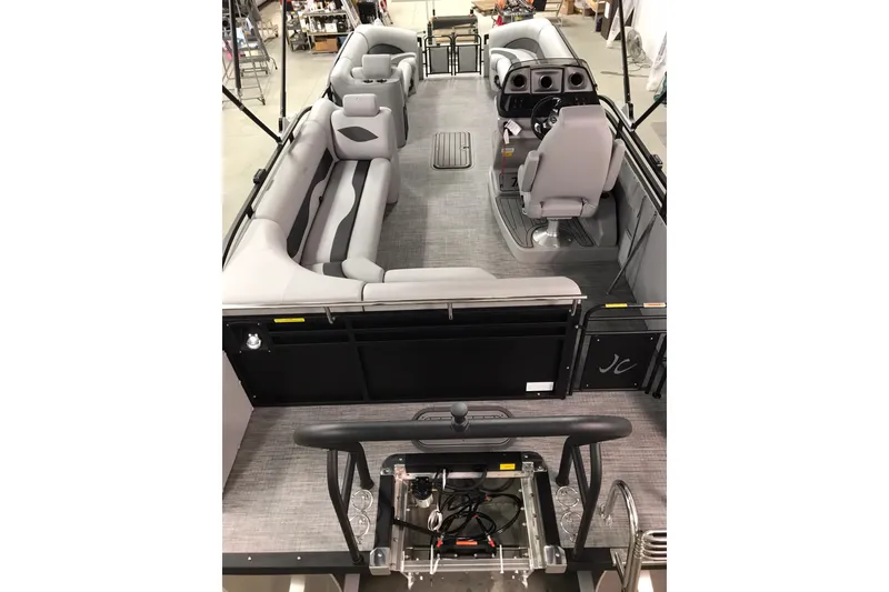 Slide: The Image of 2026 JC NEPTOON SPORT 21TT pontoon boat interior with gray seating and helm. - 16