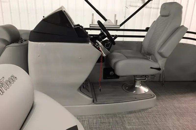 Slide: The Image of 2026 JC NEPTOON SPORT 21TT boat interior with gray captain's chair and steering console. - 9