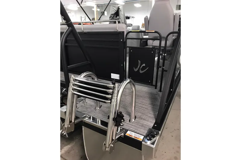 Slide: The Image of 2026 JC NEPTOON SPORT 21TT boat with ladder and seating area in showroom. - 17