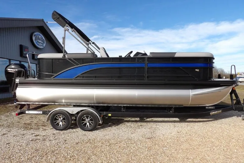 The Image of 2026 Bennington S 22 SSR pontoon boat on trailer, parked outdoors. - 1