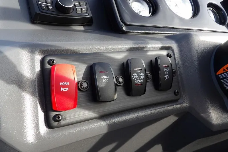 Slide: The Image of Control panel of 2026 Bennington S 22 SSR with horn, radio, and light switches. - 20