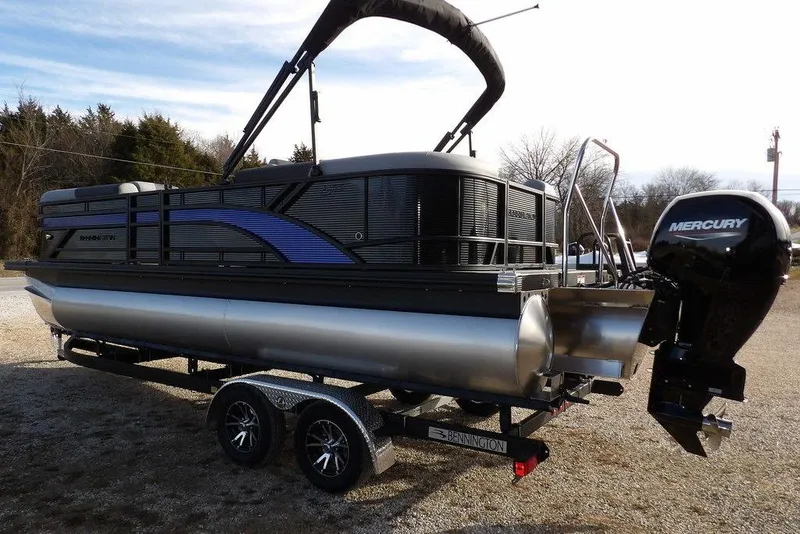 Slide: The Image of 2026 Bennington S 22 SSR pontoon boat with Mercury outboard engine on trailer. - 6
