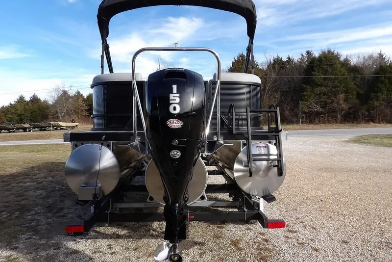 Slide: The Image of 2026 Bennington S 22 SSR pontoon boat with 150 HP motor, parked outdoors. - 7