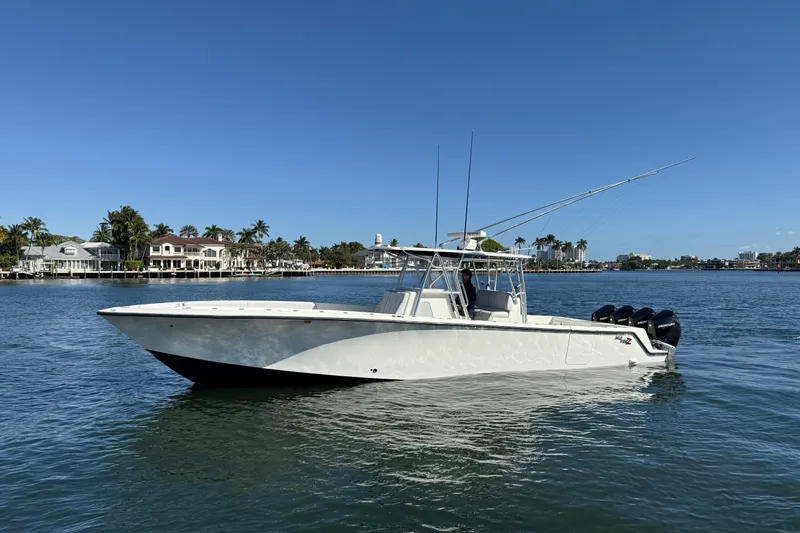 The Image of 2018 SeaVee 390Z boat on calm water, clear sky, coastal background. - 0