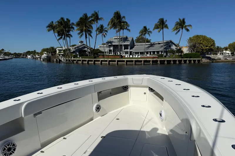 Slide: The Image of 2018 SeaVee 390Z boat on water near palm trees and waterfront homes. - 10