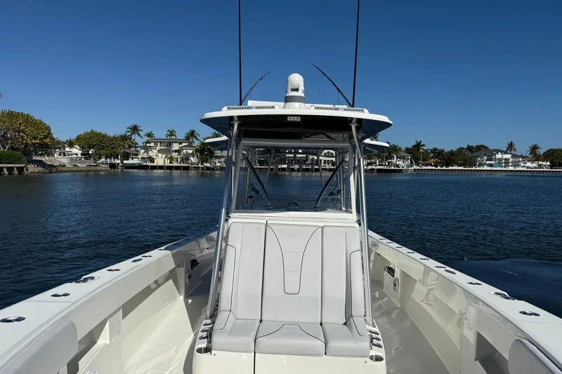 Slide: The Image of 2018 SeaVee 390Z boat on calm water with coastal homes in the background. - 12