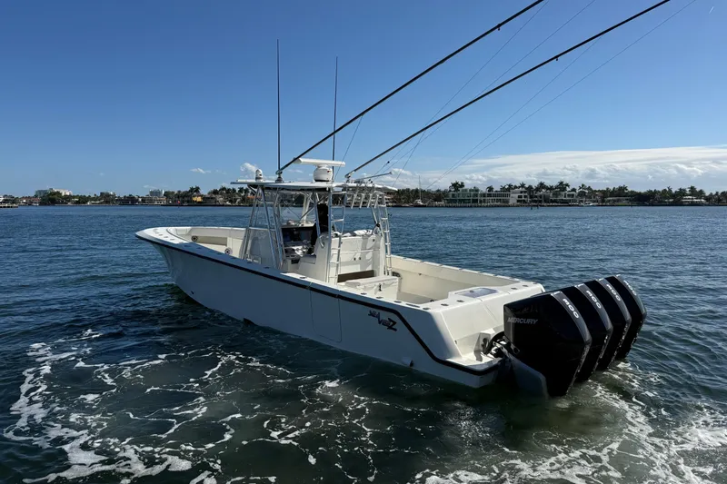 Slide: The Image of 2018 SeaVee 390Z boat with triple Mercury engines on open water. - 2