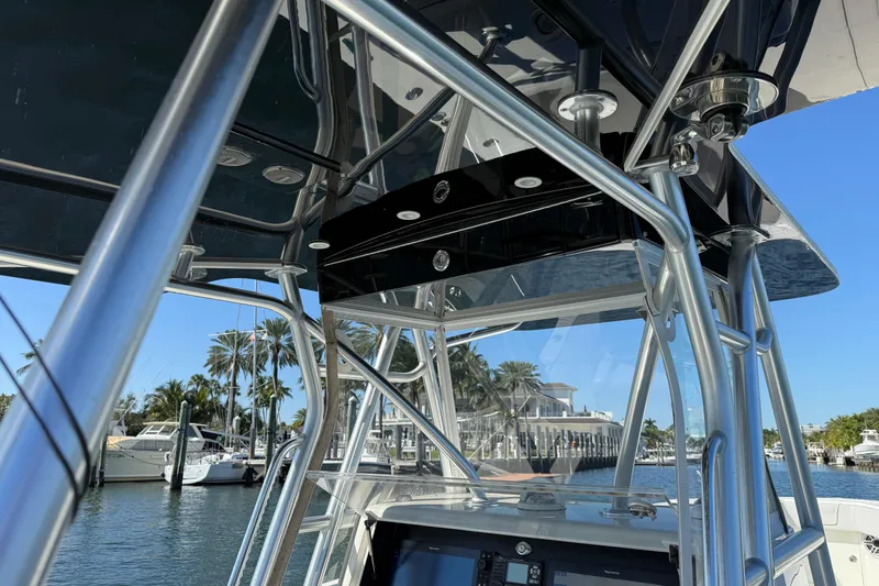 Slide: The Image of 2018 SeaVee 390Z boat with sleek metal framework and marina backdrop. - 20