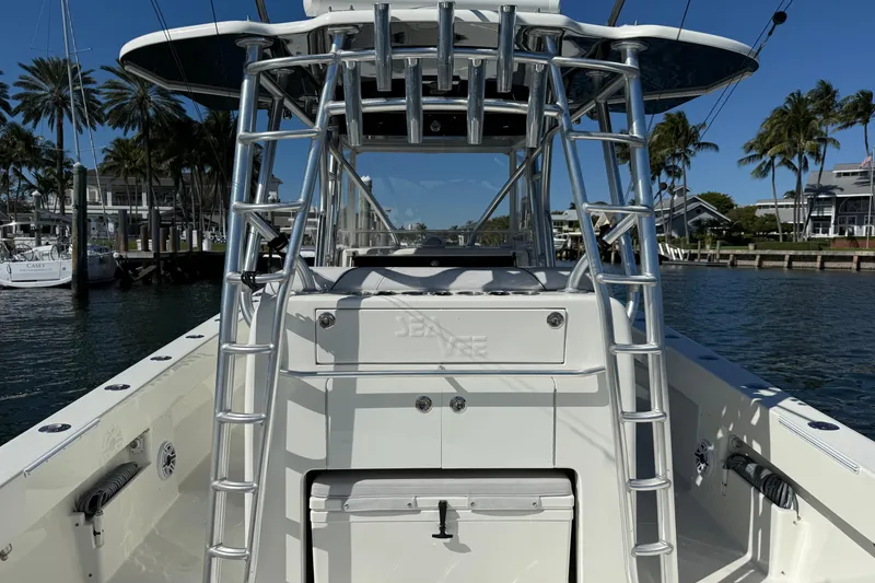 Slide: The Image of 2018 SeaVee 390Z boat with T-top and ladder, docked in a marina. - 22