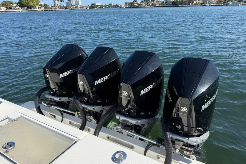 Slide: The Image of Four Mercury outboard engines on a 2018 SeaVee 390Z boat in calm waters. - 25