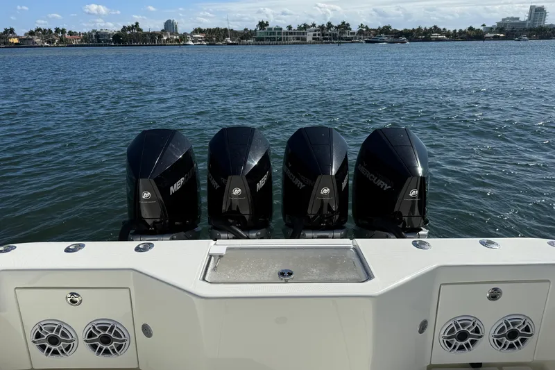 Slide: The Image of 2018 SeaVee 390Z boat with four Mercury outboard engines on a calm water backdrop. - 26