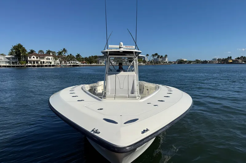 Slide: The Image of 2018 SeaVee 390Z boat on calm water with coastal homes in the background. - 30