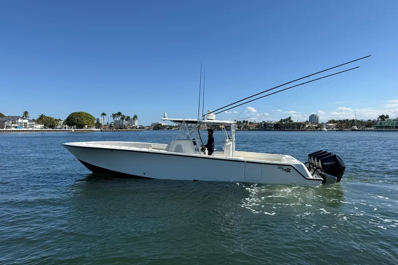 Slide: The Image of 2018 SeaVee 390Z boat cruising on a sunny day near a coastal city. - 35