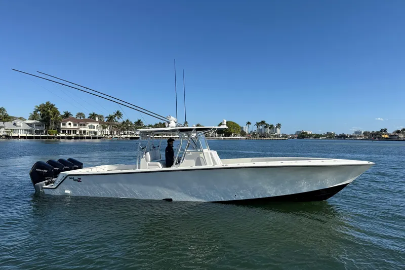 Slide: The Image of 2018 SeaVee 390Z boat on calm water, clear sky, coastal background. - 5