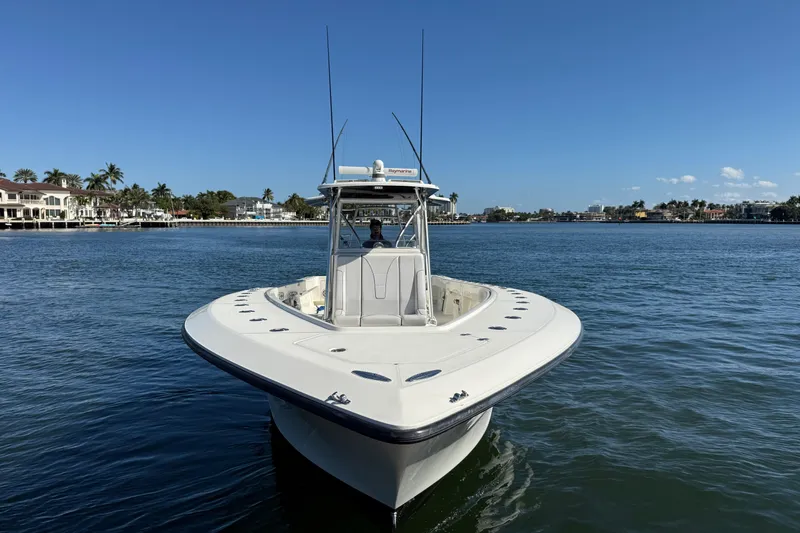 Slide: The Image of 2018 SeaVee 390Z boat on calm water with coastal homes in the background. - 6