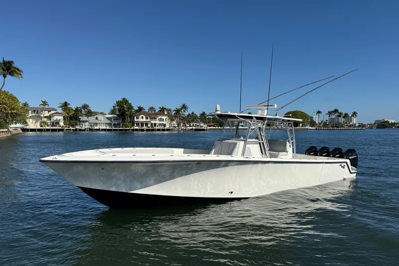 Slide: The Image of 2018 SeaVee 390Z boat on calm water, with waterfront homes in the background. - 7