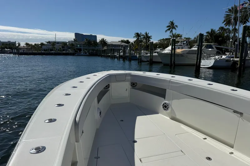 Slide: The Image of 2018 SeaVee 390Z boat docked in a sunny marina with palm trees. - 8
