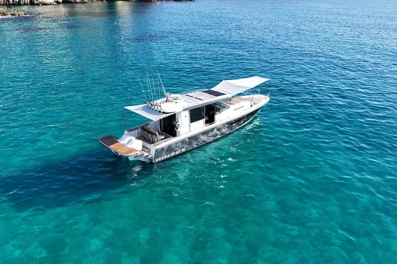 Slide: The Image of Nimbus Commuter 11 boat 2025 on clear water. - 3