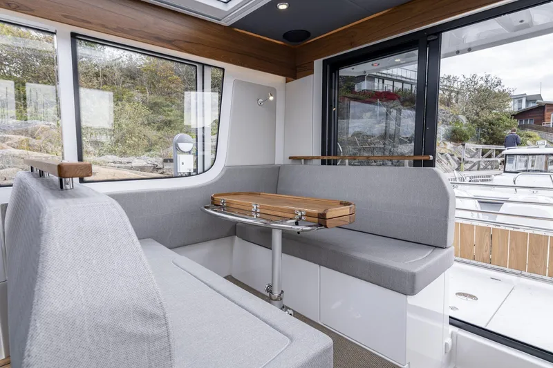 Slide: The Image of Interior of Nimbus Commuter 11 boat, 2025 model, featuring gray seating. - 7