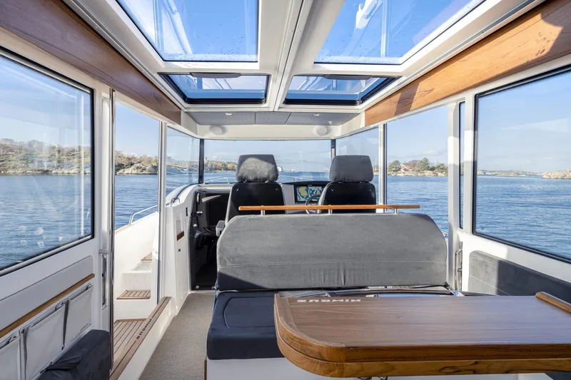 Slide: The Image of Interior of Nimbus Commuter 11 boat, 2025 model, featuring panoramic windows. - 9