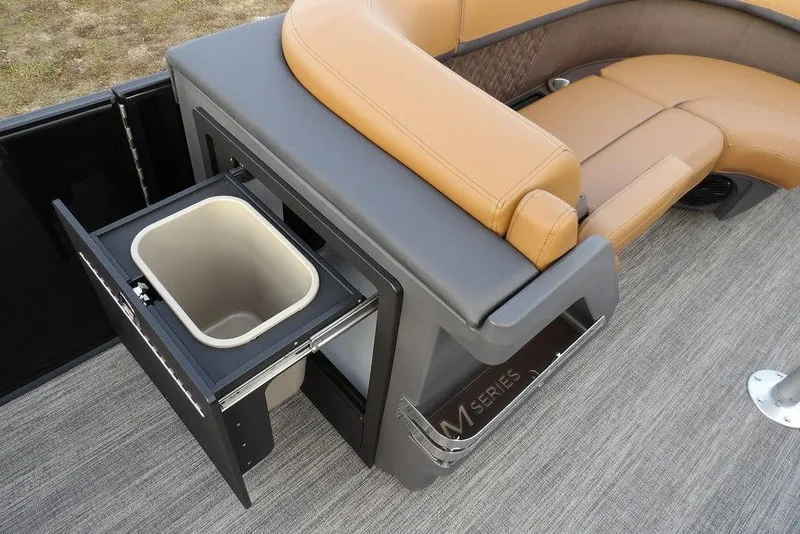 Slide: The Image of 2026 Bennington 22 MFB boat interior with tan seating and built-in storage compartment. - 17