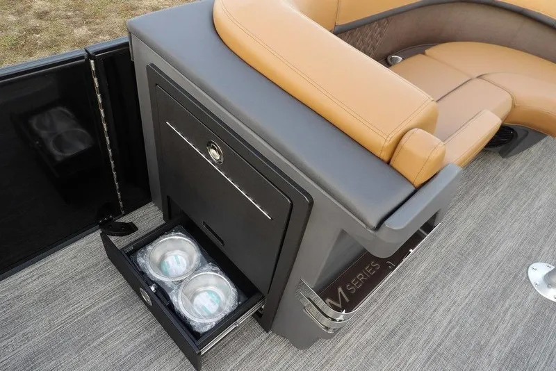 Slide: The Image of 2026 Bennington 22 MFB boat interior with tan seating and storage drawer. - 18
