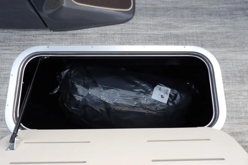 Slide: The Image of Open storage compartment on 2026 Bennington 22 MFB boat, showing interior contents. - 21