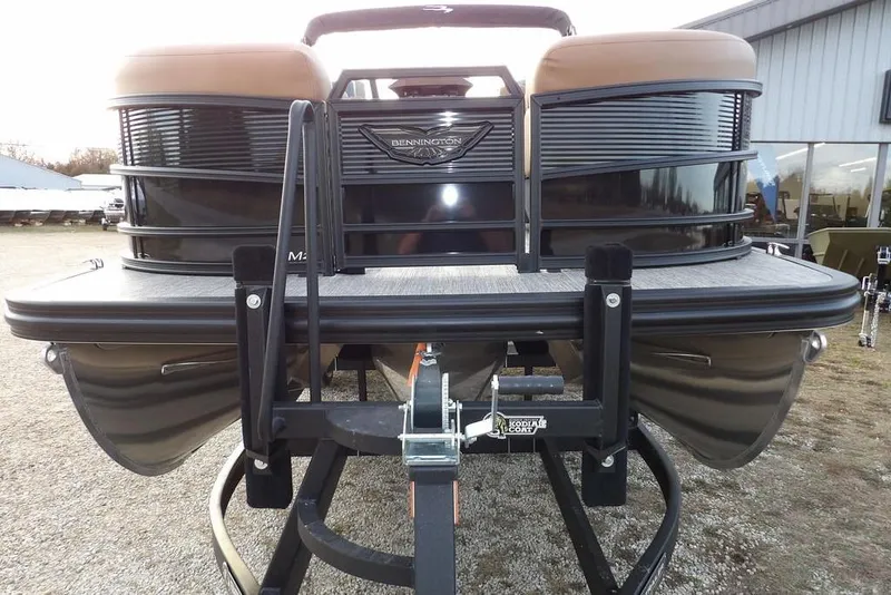 Slide: The Image of 2026 Bennington 22 MFB pontoon boat on trailer, front view, outdoor setting. - 8