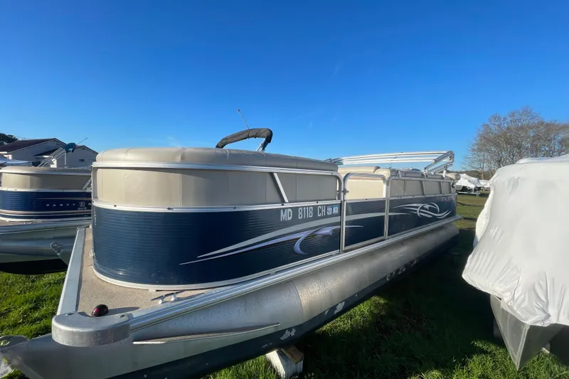 The Image of 2012 Starcraft Stardeck 206 Cruise pontoon boat on grass under clear blue sky. - 2