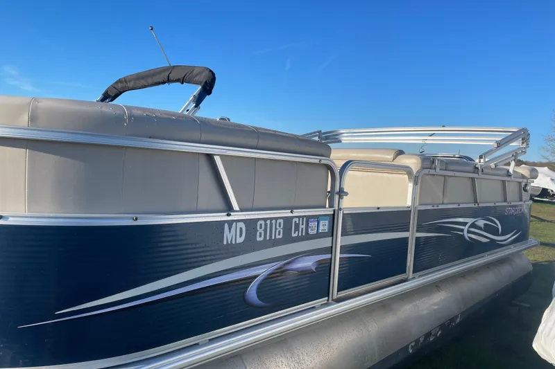 Slide: The Image of 2012 Starcraft Stardeck 206 Cruise pontoon boat with blue and beige design. - 5