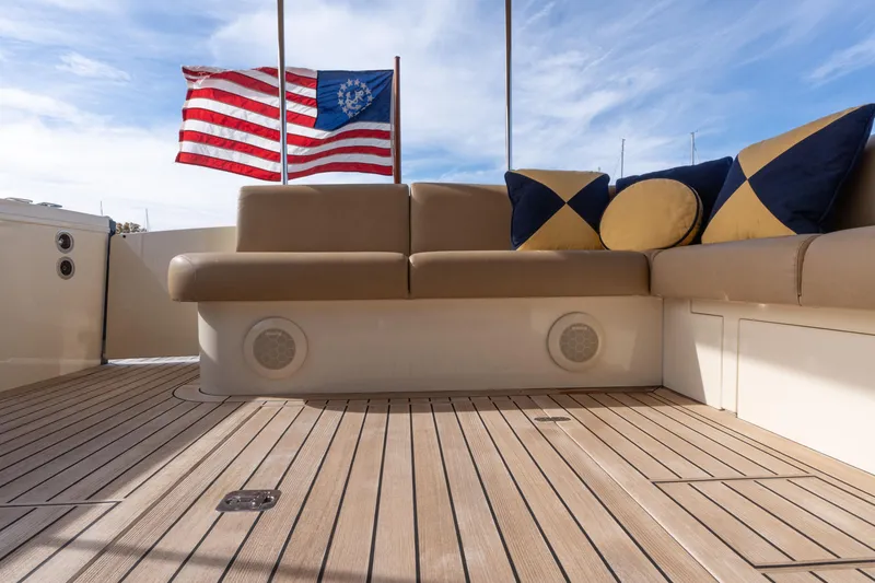 Slide: The Image of Luxury 2016 Palm Beach Motor Yachts PB50 deck with seating and nautical flag. - 32