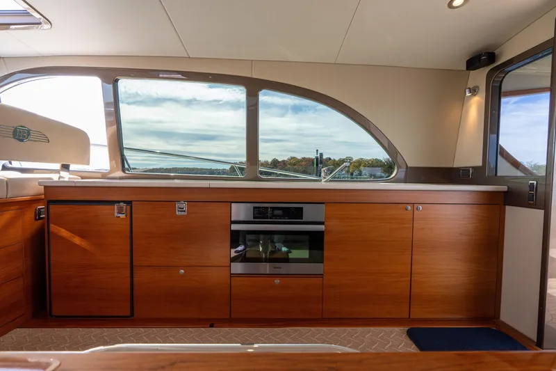 Slide: The Image of Luxurious interior of 2016 Palm Beach Motor Yachts PB50 with sleek wood cabinetry and modern appliances. - 36