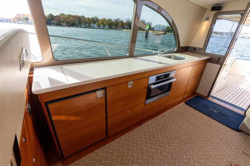 Slide: The Image of Luxurious 2016 Palm Beach Motor Yachts PB50 interior with sleek kitchen and scenic water view. - 37