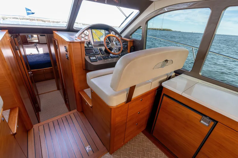 Slide: The Image of 2016 Palm Beach Motor Yachts PB50 interior with wooden helm and ocean view. - 42