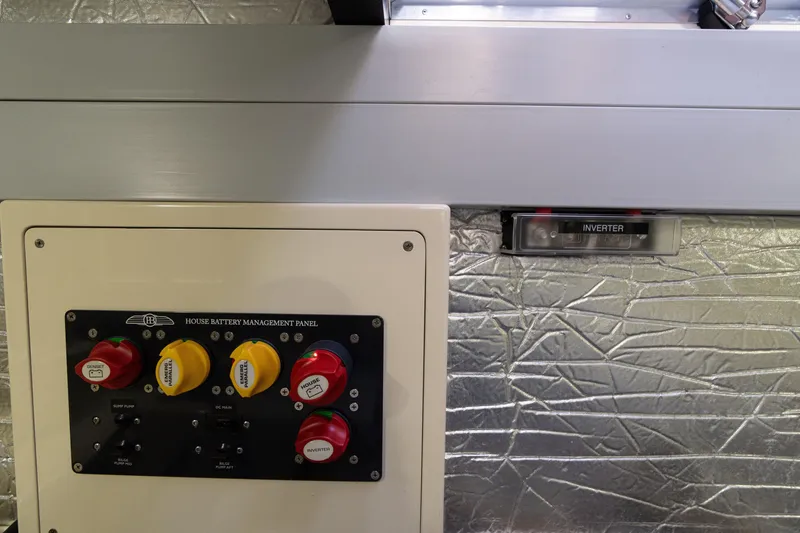 Slide: The Image of House battery management panel on 2016 Palm Beach Motor Yachts PB50, featuring inverter controls. - 53