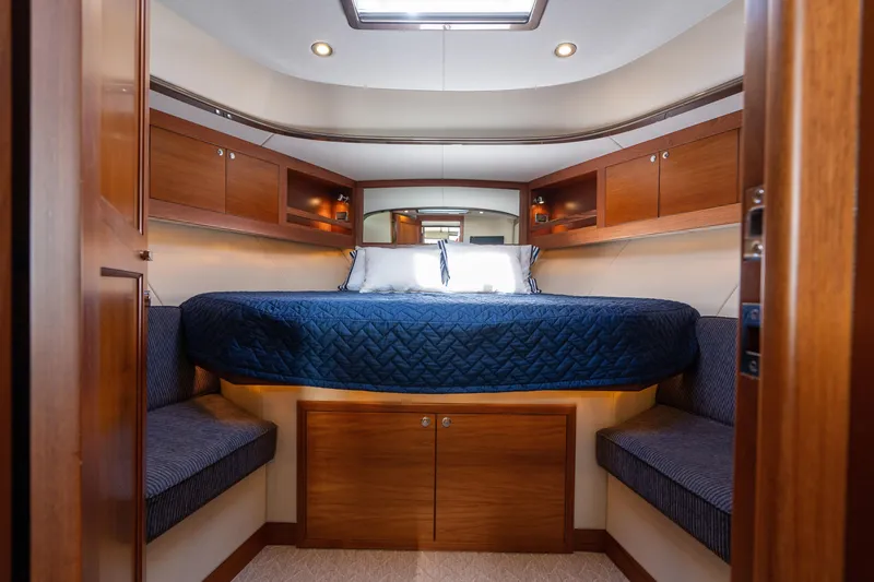 Slide: The Image of Luxurious 2016 Palm Beach Motor Yachts PB50 cabin with elegant wood finish and cozy bedding. - 57
